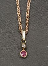 NINE CARAT ROSE GOLD NECKCHAIN with a diamond and ruby pendant, approximately 4.8 grams