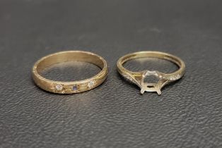 TWO NINE CARAT GOLD RINGS comprising a band set with a sapphire flanked by a diamond and a CZ;