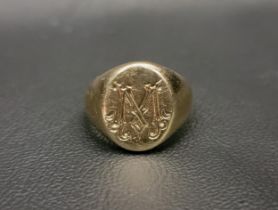 NINE CARAT GOLD SIGNET RING the oval signet ring engraved with an ornamental 'M', approximately 8.