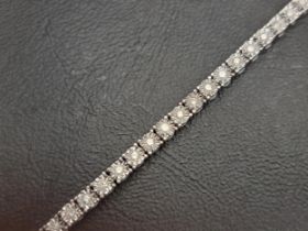 DIAMOND LINE BRACELET the 48 illusion set diamonds totalling approximately 1ct, in ten carat white