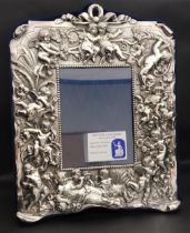 ELIZABETH II BRITANNIA SILVER PHOTOGRAPH FRAME decorated with putti in relief, London 1997 by Neil