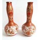 PAIR OF JAPANESE KUTANI BOTTLE NECK VASES decorated with panels of figures in a garden with birds