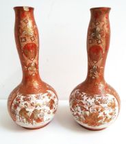 PAIR OF JAPANESE KUTANI BOTTLE NECK VASES decorated with panels of figures in a garden with birds