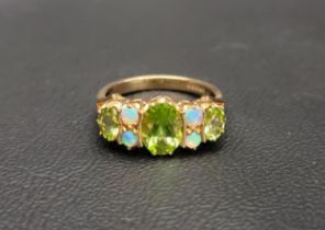 PRETTY PERIDOT AND OPAL DRESS RING the central oval cut peridot approximately 1ct, flanked by two