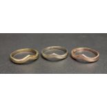 MATCHING SET OF THREE FOURTEEN CARAT GOLD WISHBONE STYLE RINGS in white, yellow and rose gold, all