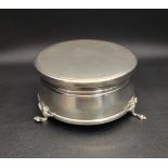 SILVER TRINKET BOX the circular box raised on three paw feet, with hinged cover and velvet lined