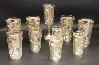 SET OF TEN MEXICAN SILVER OVERLAID SHOT GLASSES of varying sizes, the bases marked 'Mexico