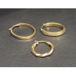 THREE GOLD HOOP EARRINGS the two nine carat gold oval hoops, one with a Celtic motif, along with one