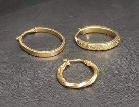 THREE GOLD HOOP EARRINGS the two nine carat gold oval hoops, one with a Celtic motif, along with one