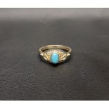 TURQUOISE DRESS RING the central cabochon turquoise in moulded setting with decorative floral