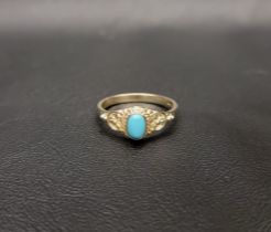 TURQUOISE DRESS RING the central cabochon turquoise in moulded setting with decorative floral