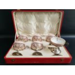 SET OF SIX GEORGE V SILVER CUPS raised on a circular foot with a pierced bowl and scroll handle,