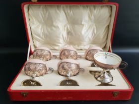 SET OF SIX GEORGE V SILVER CUPS raised on a circular foot with a pierced bowl and scroll handle,