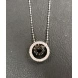 BLACK AND WHITE DIAMOND SET PENDANT the central ring of black diamonds within an outer ring of white
