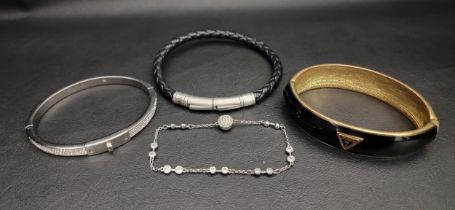 SELECTION OF FASHION JEWELLERY comprising a Guess hinge bracelet, a Fossil leather bracelet, a