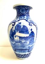 EARLY 20th CENTURY JAPANESE BLUE AND WHITE VASE of baluster form decorated with flowers and two