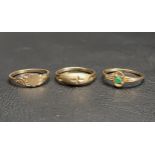 THREE SMALL TEN CARAT GOLD RINGS one with emerald, another with central heart panel, and the the