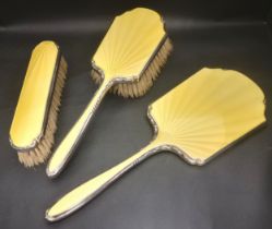 THREE PIECE ENAMEL DECORATED SILVER DRESSING TABLE SET comprising two brushes and a hand mirror, all