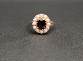 GARNET AND PEARL CLUSTER RING the central oval cut garnet approximately 1ct in twelve pearl