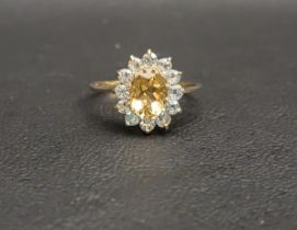 PRETTY CITRINE AND BLUE TOPAZ CLUSTER RING the central oval cut citrine measuring approximately 1ct,