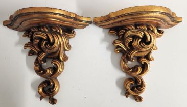 PAIR OF GILTWOOD WALL BRACKETS with shaped tops above entwined scrolls, 28cm x 30cm (2)