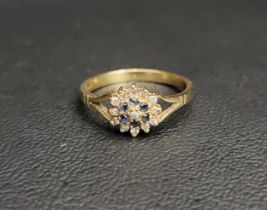DIAMOND AND SAPPHIRE CLUSTER RING the central diamond in sapphire and outer diamond surround, on
