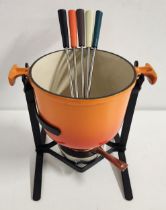 LE CRUESET FONDUE SET in enamelled orange with a burner and cover, stand and five long forks with