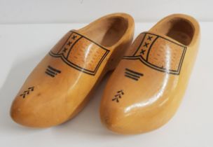 PAIR OF CARVED WOODEN CLOGS with applied decoration