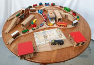 LARGE SELECTION OF BRIO including trains, carriages, track, bridges, tunnels and a printed lay out