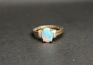 OPAL AND DIAMOND DRESS RING the central oval cabochon opal measuring approximately 8.9mm x 7.1mm,