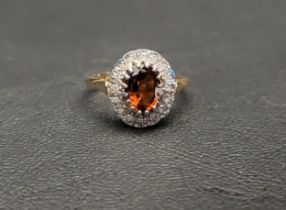 CITRINE AND DIAMOND CLUSTER RING the central oval cut citrine approximately 1ct in a sixteen diamond