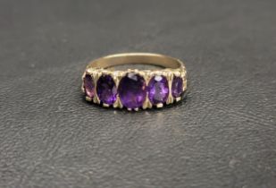 AMETHYST FIVE STONE RING the five graduated oval cut amethysts ranging from approximately 0.7cts