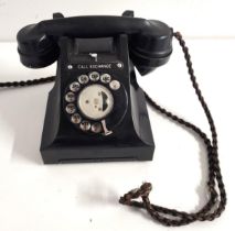 VINTAGE BAKELITE TELEPHONE with a one piece handset with original plaited cord, circular dial with