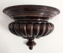 MAHOGANY WALL BRACKET with a moulded semi elliptical top above a lobed body, 22cm x 33cm