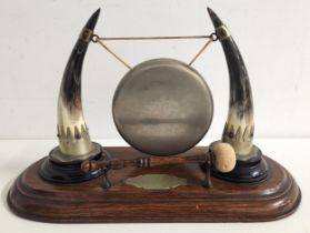 19th CENTURY TABLE GONG on an oak shaped rectangular base with a circular gong supported between two