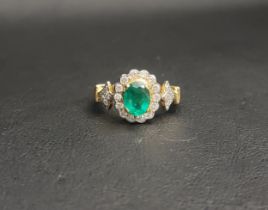 EMERALD AND DIAMOND CLUSTER RING the central oval cut emerald approximately 1.1cts in fourteen