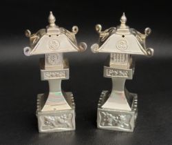 STERLING SILVER PAGODA SALT AND PEPPER SHAKERS both with embossed decoration, 7.3cm high and total