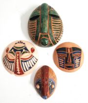 FOUR TERRACOTTA MINATURE AFRICAN MASKS one with a green glaze marked Batantuy 6/2/20 to verso, 12.