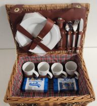 WICKER PICNIC BASKET with closure straps and carry handle, the fitted interior for four people