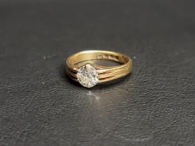 DIAMOND SOLITAIRE RING the round brilliant cut diamond approximately 0.8cts, flanked by decorative