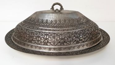 TURKISH WHITE METAL SERVING BOWL AND COVER of oval form with hammered and engraved decoration,