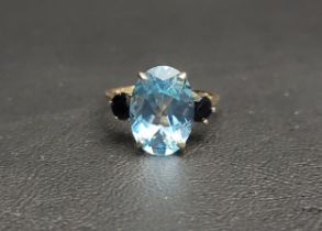IMPRESSIVE BLUE TOPAZ AND SAPPHIRE THREE STONE RING the central oval cut topaz measuring