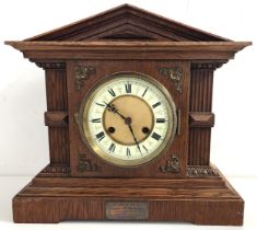 VICTORIAN OAK CASED MANTLE CLOCK with a circular enamelled dial with Roman numerals and an eight day