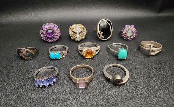 INTERESTING SELECTION OF TWELVE SILVER RINGS including a multi gem set leopard head ring, an