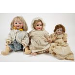 Dolls. Three small bisque-headed dolls. An Armand Marseille German baby bisque head doll model AM