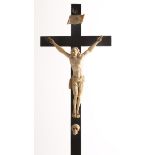 18th century, Dieppe school, carved elephant tusk crucifix on stained wood cross, the figure of