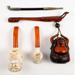 Japanese Meiji carved wood pipe and tobacco holder; together with an opium pipe and two Meersham-