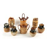A collection of Royal Doulton stoneware jugs including three Dewar's Whisky jugs, a General Gordon
