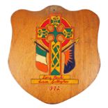 Prisoner Art, Long Kesh 1972, a shield shaped wooden panel painted with a Celtic Cross flanked by an