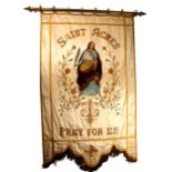 A 19th century processional banner venerating St Agnes. The cream silk banner with gilt fringes,